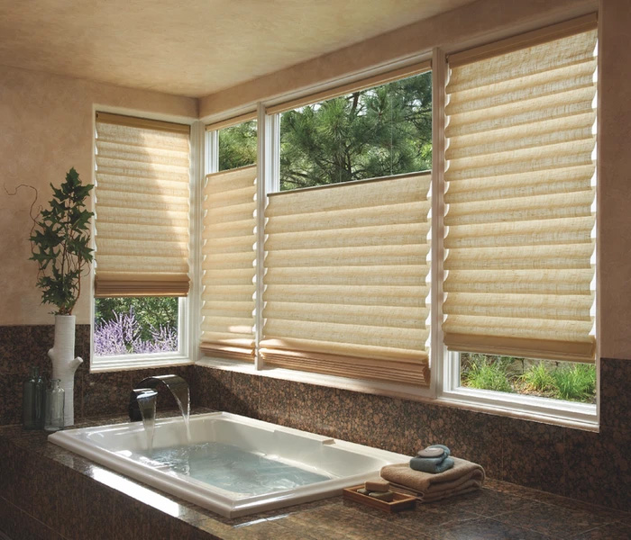 The image shows a bathroom interior with a large window covered by horizontal blinds, a tub partially visible through the window, and a sink under the window.